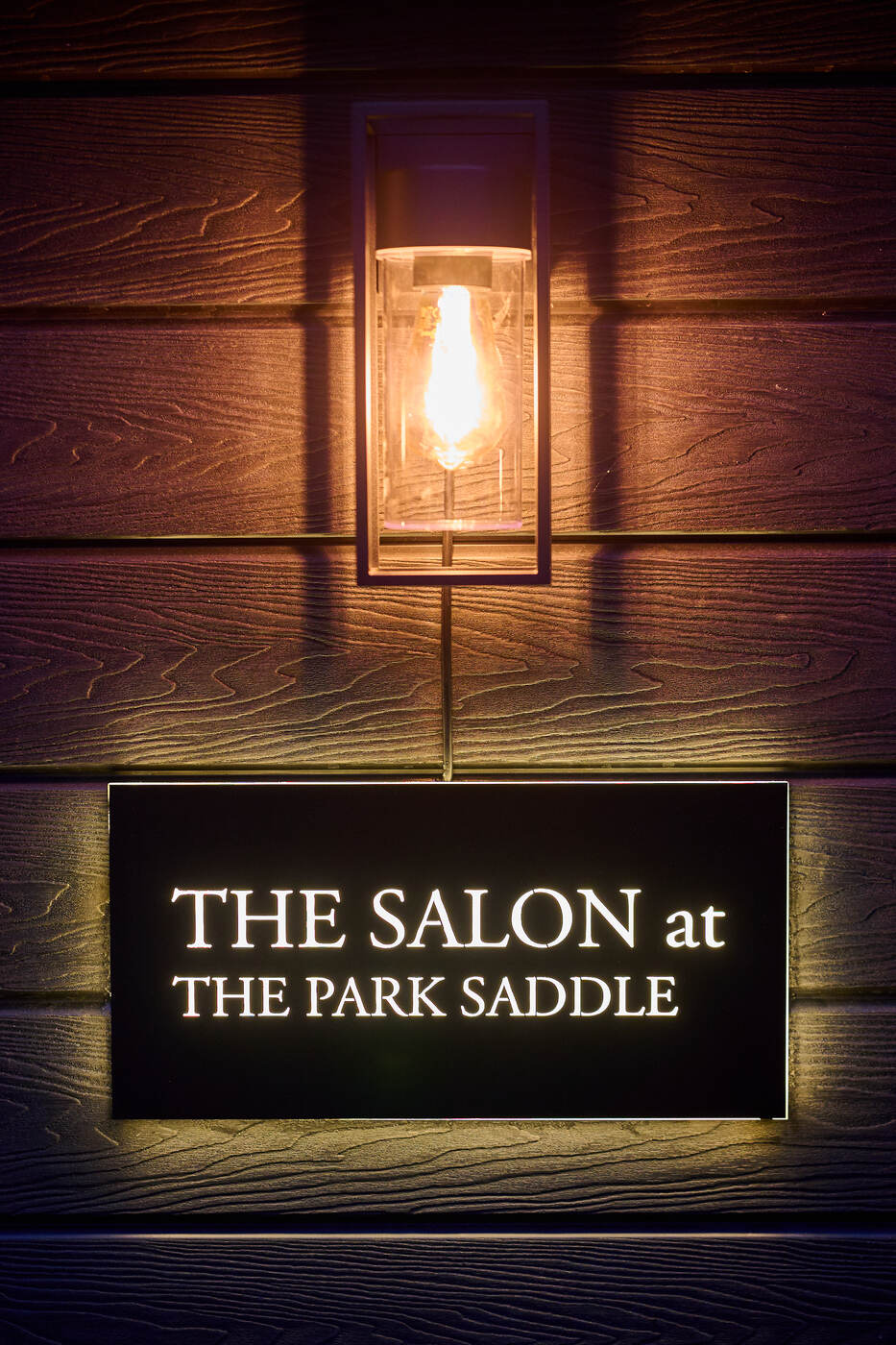 The Salon sign by lantern light